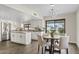 Open floor plan kitchen and dining room with wood floors and white cabinets at 10540 N 78Th Pl, Scottsdale, AZ 85258