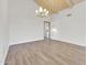 Bright living room features light wood plank flooring, cathedral ceilings, and a modern chandelier at 10540 N 78Th Pl, Scottsdale, AZ 85258