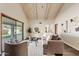 Bright living room with vaulted ceilings and a sliding glass door to the backyard at 10540 N 78Th Pl, Scottsdale, AZ 85258