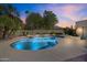 Backyard pool with built-in spa and perimeter lighting is surrounded by palm trees at sunset at 10540 N 78Th Pl, Scottsdale, AZ 85258