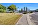 Community tennis court surrounded by lush greenery, with a walking path in the foreground at 10540 N 78Th Pl, Scottsdale, AZ 85258