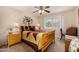 Bedroom featuring ceiling fan, window with blinds, wood furniture, and carpet at 10846 W Crosby Dr, Sun City, AZ 85351