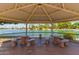 View from inside a gazebo overlooking the lake, featuring stone tables and built-in benches for community gatherings at 10846 W Crosby Dr, Sun City, AZ 85351