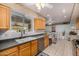 Spacious kitchen with adjacent dining area, tile flooring and wood cabinets at 10846 W Crosby Dr, Sun City, AZ 85351