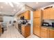 A kitchen featuring tile flooring, natural wood cabinetry, and stainless steel appliances at 10846 W Crosby Dr, Sun City, AZ 85351