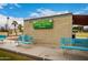 Exterior view of the Lakeview Lawn Bowl Club, with benches and brick building and blue sky at 10846 W Crosby Dr, Sun City, AZ 85351