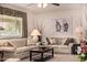 Cozy living room with two sofas, a large window, neutral decor, and decorative accent pieces at 10846 W Crosby Dr, Sun City, AZ 85351