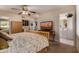 Bedroom with a desert themed television display and adjoining bathroom at 10846 W Crosby Dr, Sun City, AZ 85351