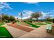 View of the community mini golf course, featuring well-maintained greens, landscaping, and shaded seating at 10846 W Crosby Dr, Sun City, AZ 85351