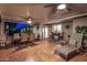 Covered patio with ceiling fans, lounge chair, outdoor furniture and tile floor at dusk at 10846 W Crosby Dr, Sun City, AZ 85351