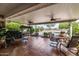 Covered patio with ceiling fans, lounge chair, outdoor furniture and tile floor at 10846 W Crosby Dr, Sun City, AZ 85351