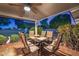 Covered patio features tile flooring, ceiling fan, and a table with seating, perfect for outdoor dining and relaxation at 10846 W Crosby Dr, Sun City, AZ 85351