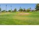 Lush golf course featuring sand traps, mature trees and residential buildings in the background at 10846 W Crosby Dr, Sun City, AZ 85351