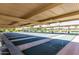 A view of the community shuffleboard courts featuring green courts, markings, and spectator benches at 10846 W Crosby Dr, Sun City, AZ 85351