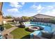 Spacious backyard boasts a built-in firepit seating and landscaped artificial turf at 1101 W Oleander Ave, Queen Creek, AZ 85140