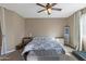 Bright bedroom with a ceiling fan, king bed, and a soft gray bench at 1101 W Oleander Ave, Queen Creek, AZ 85140