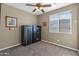 Bedroom featuring two large, dark-colored safes and a well-lit window at 1101 W Oleander Ave, Queen Creek, AZ 85140