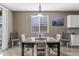 Inviting dining area with a modern table set, natural light, and serene mountain artwork at 1101 W Oleander Ave, Queen Creek, AZ 85140