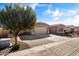 Well-maintained single-story home featuring desert landscaping, a two-car garage, and wide driveway at 1101 W Oleander Ave, Queen Creek, AZ 85140