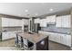 Bright kitchen featuring white cabinetry, granite countertops, stainless appliances, and seating at the island at 1101 W Oleander Ave, Queen Creek, AZ 85140