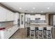 Modern kitchen with white cabinetry, granite countertops, stainless steel appliances, and a large island at 1101 W Oleander Ave, Queen Creek, AZ 85140