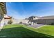 An open backyard provides ample space with artificial grass, gravel, and a seating area at 11679 W Parkway Ln, Avondale, AZ 85323