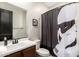 Bathroom with single sink vanity, black fixtures, toilet, and Star Wars themed shower curtain at 11679 W Parkway Ln, Avondale, AZ 85323