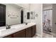 Bathroom with double vanity, framed mirrors, and separate toilet and shower room at 11679 W Parkway Ln, Avondale, AZ 85323