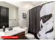 Modern bathroom featuring a dark wood vanity, toilet and a themed shower curtain at 11679 W Parkway Ln, Avondale, AZ 85323