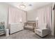 Charming Bedroom with decorative chandelier, comfortable armchair, and baby furniture at 11679 W Parkway Ln, Avondale, AZ 85323