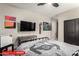 The bedroom with ceiling fan, mounted TV, and playful decor at 11679 W Parkway Ln, Avondale, AZ 85323