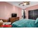 Charming bedroom with soft pink walls, a ceiling fan, and comfortable furniture at 11679 W Parkway Ln, Avondale, AZ 85323