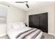 Cozy bedroom featuring a ceiling fan, neutral color palette, and built-in wardrobe with sliding doors at 11679 W Parkway Ln, Avondale, AZ 85323