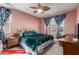 A stylish bedroom with a brass bed frame, colorful bedding, and coordinating curtains at 11679 W Parkway Ln, Avondale, AZ 85323