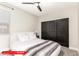 Cozy bedroom features a comfortable bed with plush bedding and dark sliding closet doors at 11679 W Parkway Ln, Avondale, AZ 85323