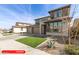 Front exterior showcasing desert landscaping, a well-maintained lawn, and a three-car garage at 11679 W Parkway Ln, Avondale, AZ 85323