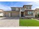 Charming two-story home with a three car garage, manicured landscaping and brick paved driveway at 11679 W Parkway Ln, Avondale, AZ 85323