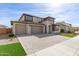 Lovely two-story home with a three-car garage, attractive exterior, and charming landscaping at 11679 W Parkway Ln, Avondale, AZ 85323