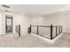 Light and bright hallway featuring modern railings and neutral color palette at 11679 W Parkway Ln, Avondale, AZ 85323