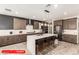 A gorgeous kitchen with an island, pendant lights, stainless steel appliances, and a modern design at 11679 W Parkway Ln, Avondale, AZ 85323