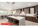 Spacious kitchen with a large island, modern lighting, stainless steel appliances, and beautiful cabinetry at 11679 W Parkway Ln, Avondale, AZ 85323