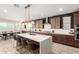 Spacious kitchen featuring a large island, modern lighting, and seamlessly connected dining area for entertaining at 11679 W Parkway Ln, Avondale, AZ 85323