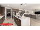 Open-concept kitchen with stainless steel appliances, a large island, and seamless flow to the living area at 11679 W Parkway Ln, Avondale, AZ 85323