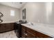 Spacious laundry room with sink, washer, dryer, countertop, and wooden cabinets at 11679 W Parkway Ln, Avondale, AZ 85323