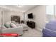 Cozy living room features a comfortable gray sectional sofa, TV and natural light at 11679 W Parkway Ln, Avondale, AZ 85323