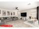 Light-filled living room featuring a ceiling fan, hardwood floors, and a sectional sofa at 11679 W Parkway Ln, Avondale, AZ 85323