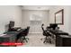 A functional home office space with two desks, ergonomic chairs, and ample natural light at 11679 W Parkway Ln, Avondale, AZ 85323