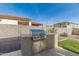 Outdoor kitchen featuring a built-in grill, offering a great space for outdoor cooking and entertainment at 11679 W Parkway Ln, Avondale, AZ 85323