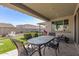 Covered patio with outdoor dining, providing a great space for entertaining and relaxation at 11679 W Parkway Ln, Avondale, AZ 85323