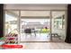 View of the patio through sliding glass doors with outdoor seating and a swing set at 11679 W Parkway Ln, Avondale, AZ 85323